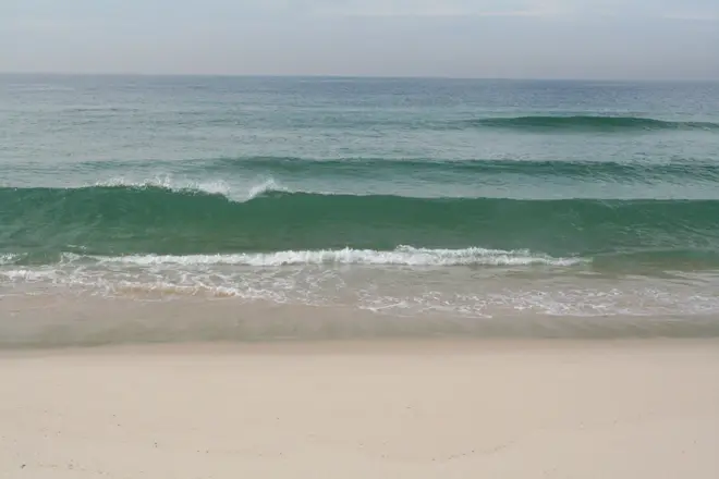 Gentle waves come in at a sandy beach