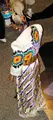Jingle dress is a dance dress worn by women participating in the "Jingle Dress Dance" at a Pow wow. Made of cloth, the dress includes several rows of metal cones, which are sewn across the dress on the skirt (and blouse, in some areas). The metal cones create a jingling sound as the dancer moves. The Jingle Dress Dance is characterized by the jingle dress and light footwork danced close to ground. The dancer dances in a snake-like pattern around the drum; her feet never cross, nor does she dance backward or turn a complete circle.