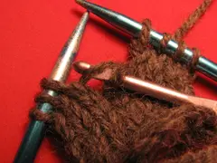 Catch the dropped stitch with the crochet hook.