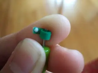 3. Keep rolling and once you get to the end of the paper strip, put a tiny dot of glue on the end of the strip and press it against the side of the circle and hold it there for 5-10 seconds for the glue to dry