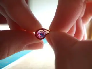 1. To make a shaped teardrop, start off with a teardrop, but curl the point downwards.